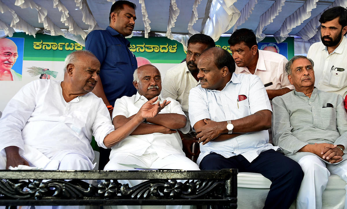 JD(S) president H D Deve Gowda, state president H Vishwanath, Chief Minister H D Kumaraswamy and MLC Basavaraj Horatti have a chat at a party meeting in Bengaluru on Thursday. DH Photo