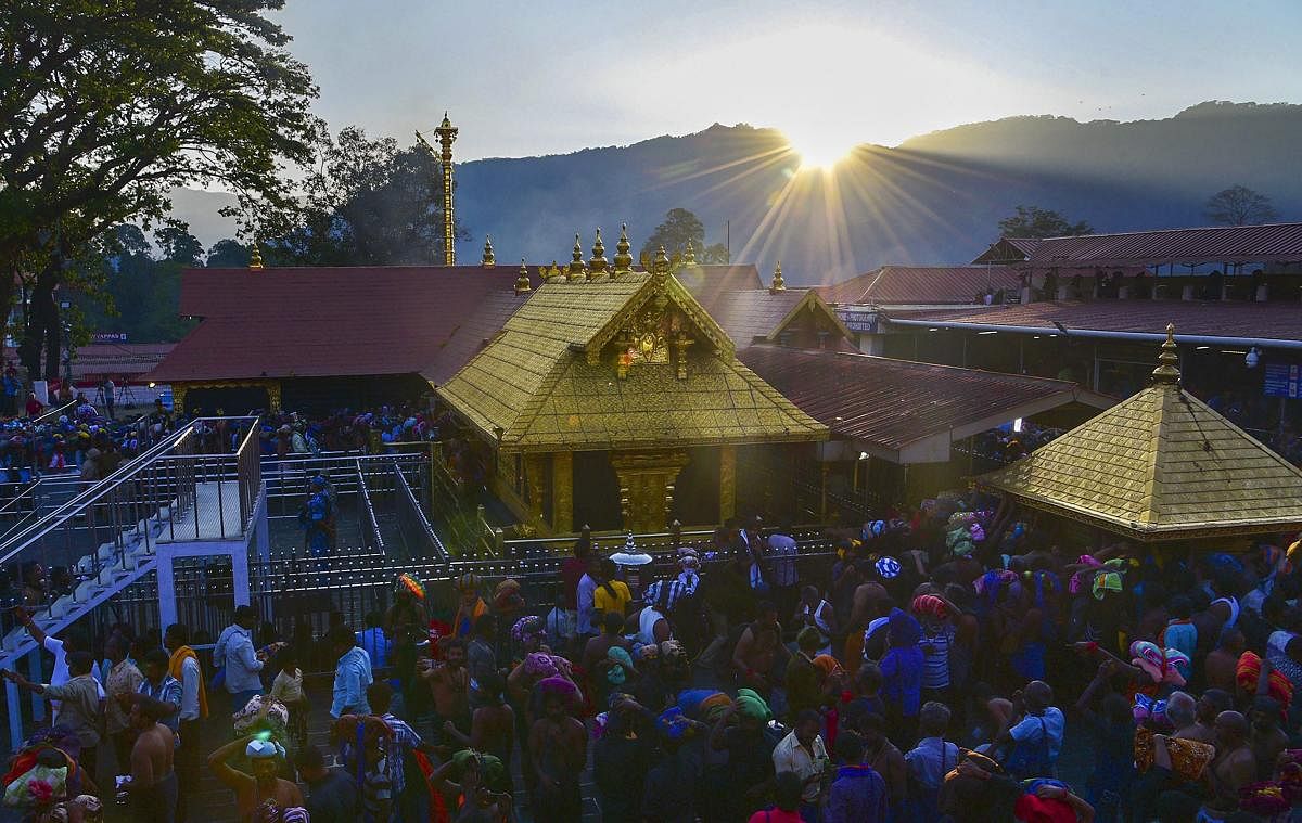 Devotees arrive to offer prayers at the Lord Ayyappa temple in Sabarimala. PTI file photo