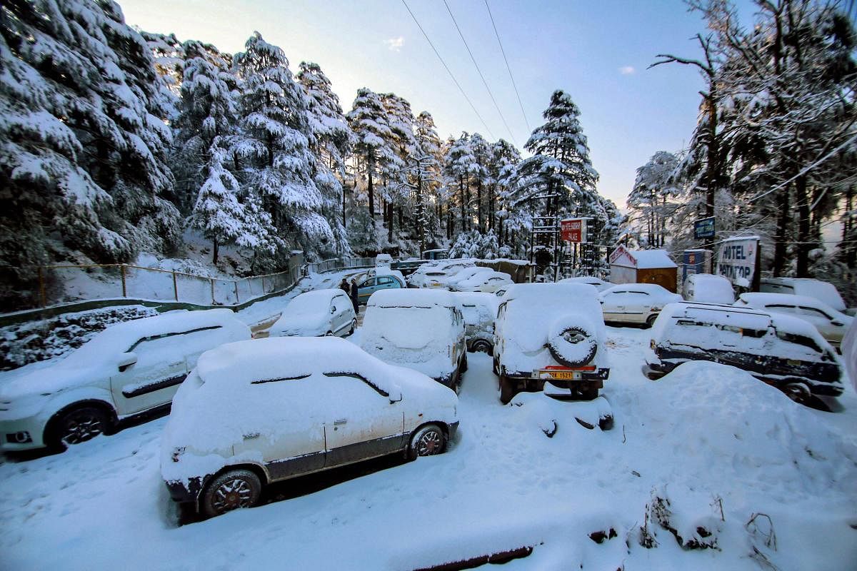 Snow-covered vehicles parked near the Jammu-Srinagar national highway, at Patnitop, about 115 km from Jammu, Sunday, Jan 13, 2019. (PTI Photo)
