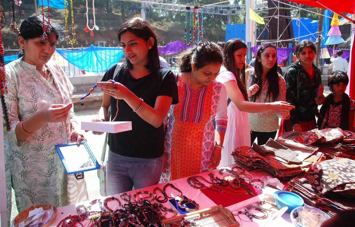 Tourists purchase chains and bags at the open street festival in Madikeri on Sunday.