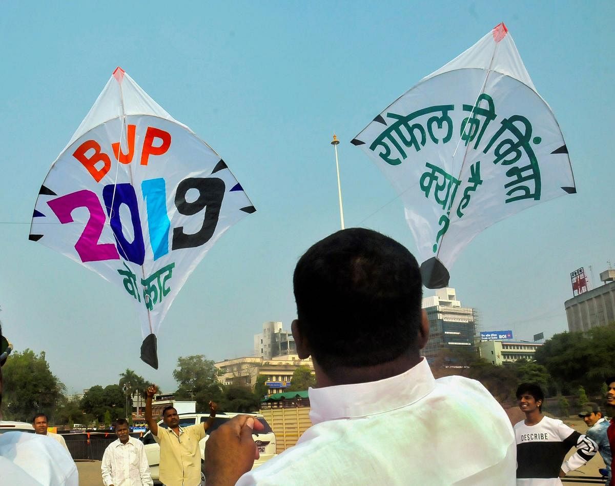 A Congress supporter flies a kite asking to address Rafael Deal scam, ahead of Makar Sankranti festival in Nagpur on Sunday. PTI file photo