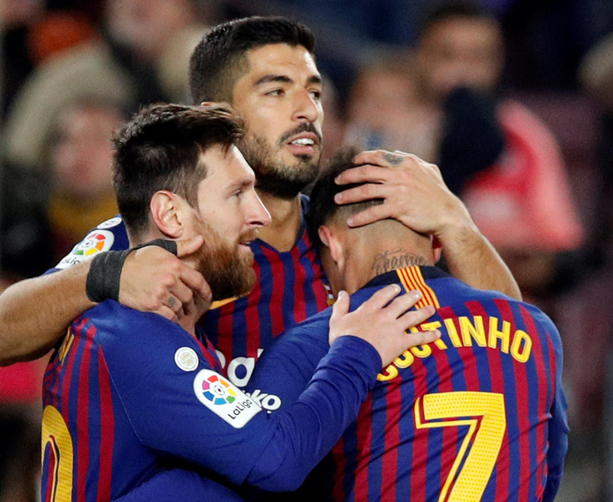 Brilliant Barcelona's Luis Suarez (centre) celebrates with team-mates Lionel Messi (left) and Philippe Coutinho after scoring against Eibar. REUTERS