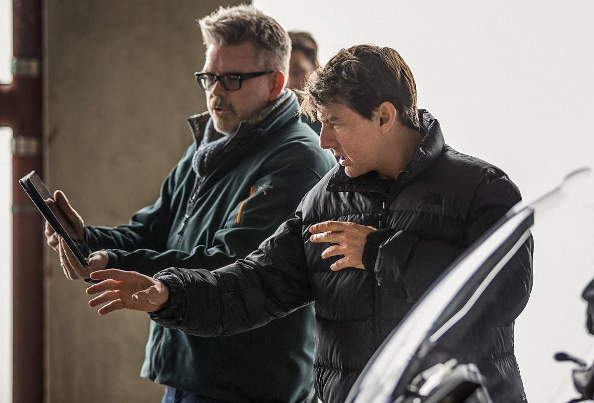 Christopher McQuarrie and actor Tom Cruise interact behind a scene on the set of Mission Impossible - Fallout. PTI/Paramount Pictures.