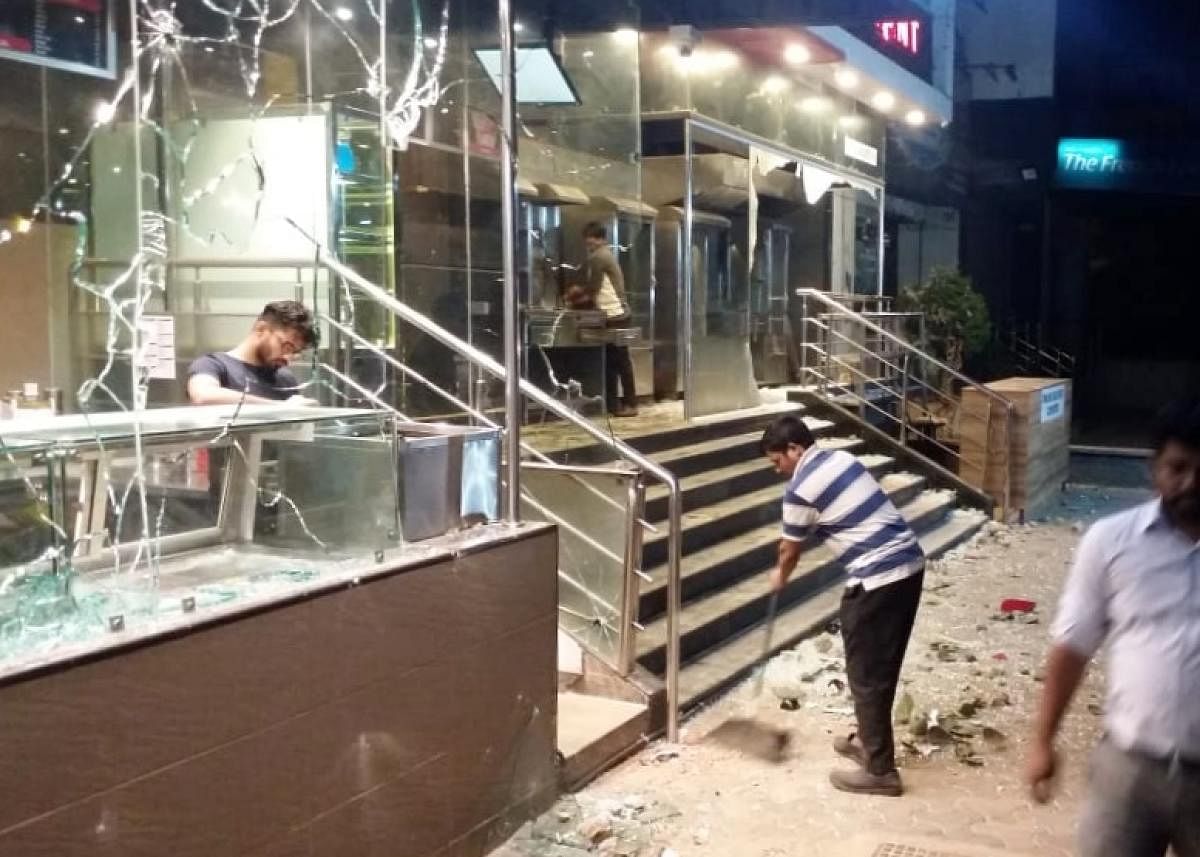 Restaurant staff clean the premises after the fight with delivery executives. 