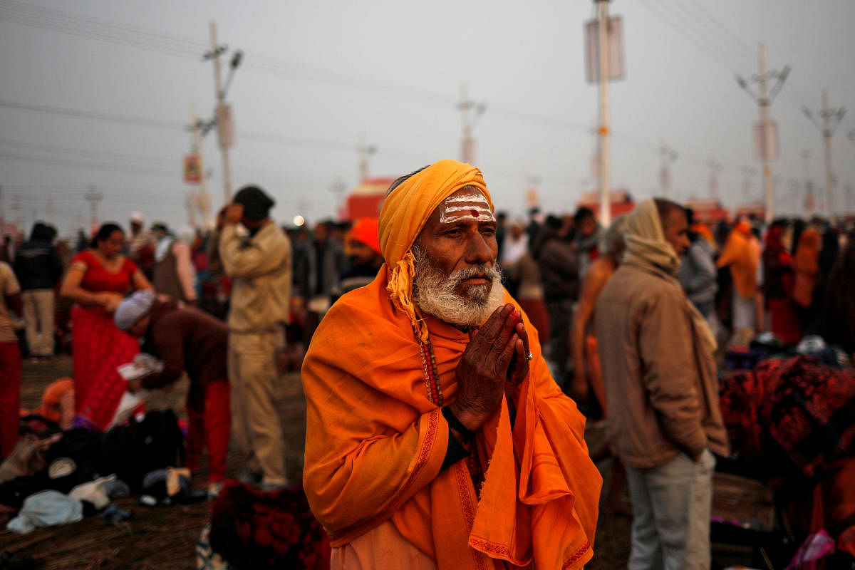 A devotee prays after taking a holy dip at Sangam, the confluence of the Ganges, Yamuna and Saraswati rivers, during "Kumbh Mela", or the Pitcher Festival, in Prayagraj, previously known as Allahabad, India, January 14, 2019. REUTERS