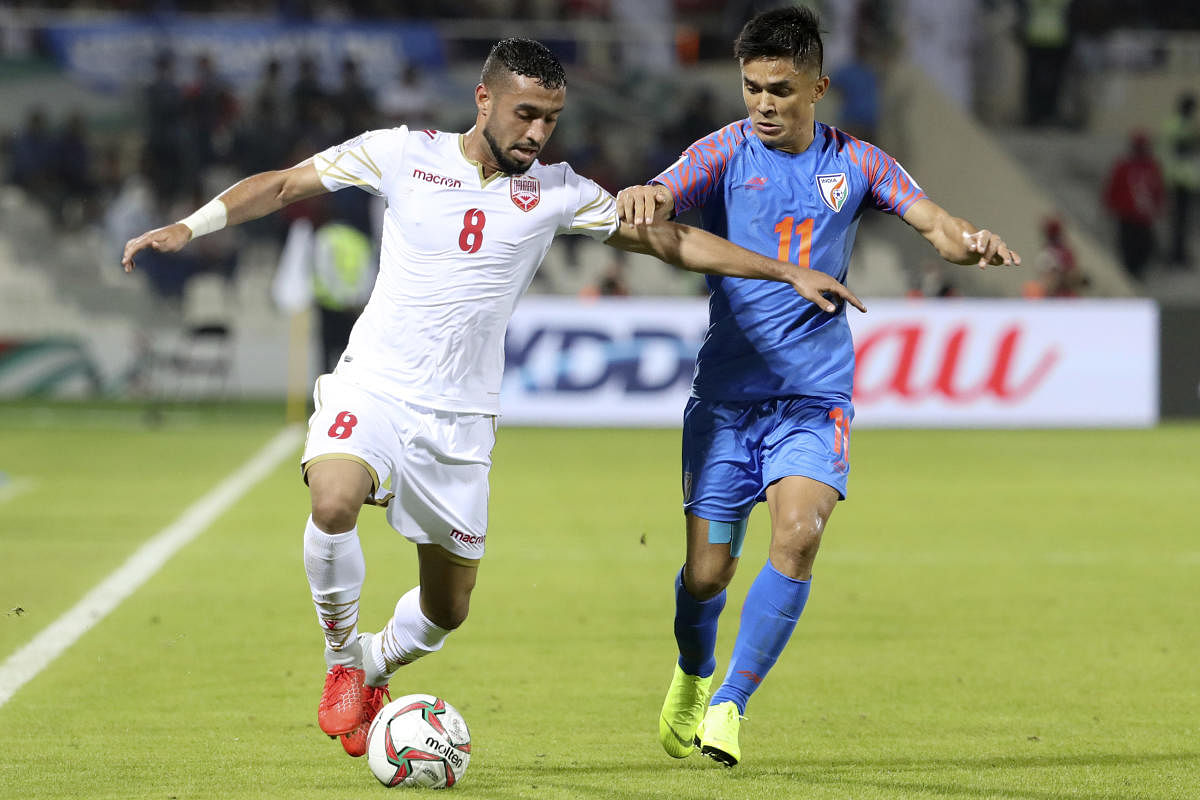India's Sunil Chhetri (right) attempts to stop Bahrain's Mohammad Marhoon during their AFC Asian Cup clash on Monday. AFP