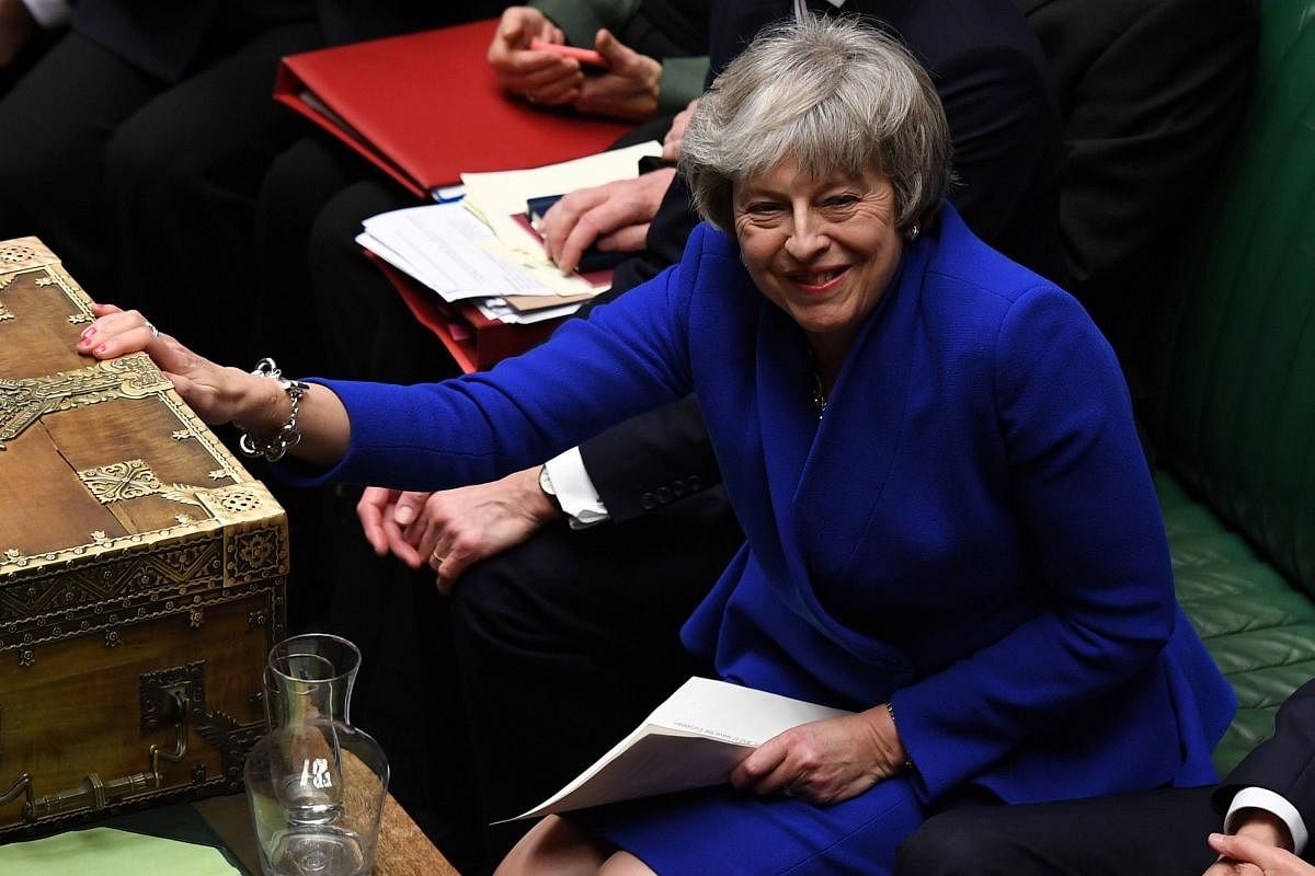 A handout photograph released by the UK Parliament's shows Britain's Prime Minister Theresa May (C) as she reacts during a debate on a no-confidence motion in the House of Commons in central London on January 16, 2019. AFP photo