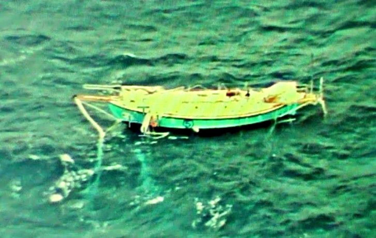 The capsized yacht Thuriya of solo sailor Abhilash Tomy is pictured at sea in this September 24, 2018 handout photo by the Indian Navy. Indian Navy/Handout via REUTERS ATTENTION EDITORS - THIS PICTURE WAS PROVIDED BY A THIRD PARTY. NO RESALES. NO ARCHIVE.