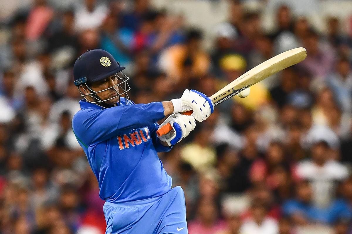 India's Mahendra Singh Dhoni plays a shot during the third one-day international cricket match between Australia and India at the Melbourne Cricket Ground. AFP Photo 