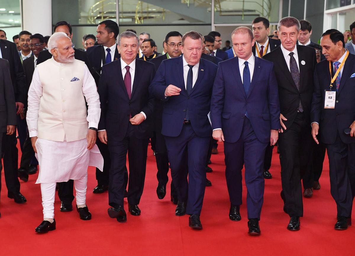 Prime Minister Narendra Modi (L) walking with visiting heads of state including Denmark's Prime Minister Lars Lokke Rasmussen (C), Malta's Prime Minister Joseph Muscat (3rd R), Czech Republic's Prime Minister Andrej Babis (2nd R) and Uzbekistan's Presiden