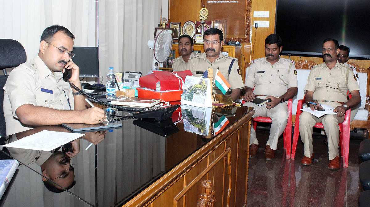 Udupi Superintendent of Police Laxman Nimbargi receives a call during the phone-in programme in Udupi.
