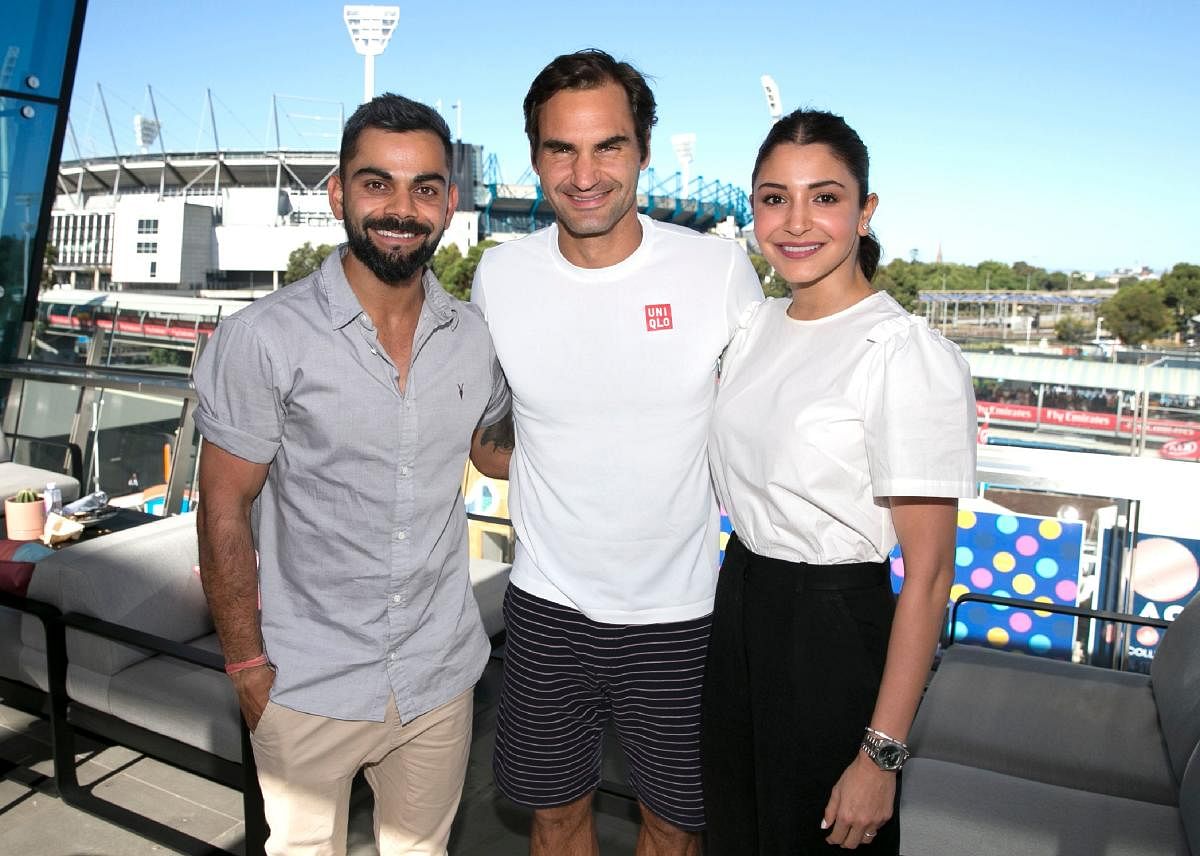 Tennis legend Roger Federer (centre) with Indian cricket skipper Virat Kohli (left) and his actor wife Anushka Sharma at the Rod Laver Arena in Melbourne on Saturday. AFP