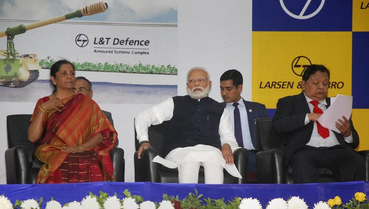 Prime Minister Narendra Modi, Defence Minister Nirmala Sitharaman and L &amp; T CEO AM Naik during the dedication of L&amp;T's Armoured System Complex to the nation in Hajira, Saturday, Jan. 19, 2019. (PTI Photo)