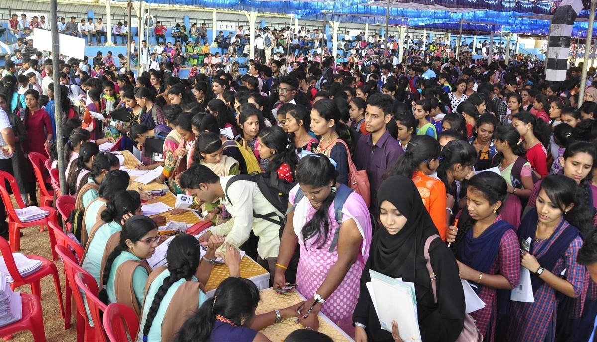 Candidates register their details at the job fair organised by Sanchalana on the premises of Dr G Shankar First Grade College at Ajjarakadu in Udupi on Saturday.