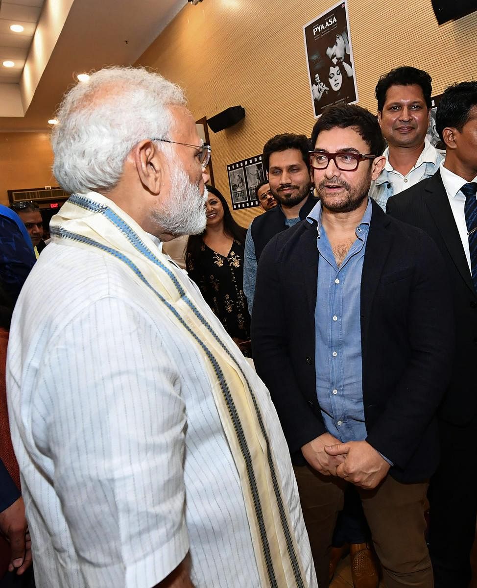 PM Narendra Modi interacts with actor Aamir Khan during the inauguration of the National Museum of Indian Cinema in Mumbai. PTI