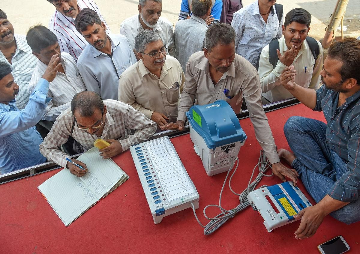 Indians try out the Electronic Voting Machine (EVM) in conjunction with the Voter-Verified Paper Audit Trail (VVPAT), a ballotless voting system, at an Election Commission demonstration stand in Mumbai on January 16, 2019. - These demonstrations are an ef