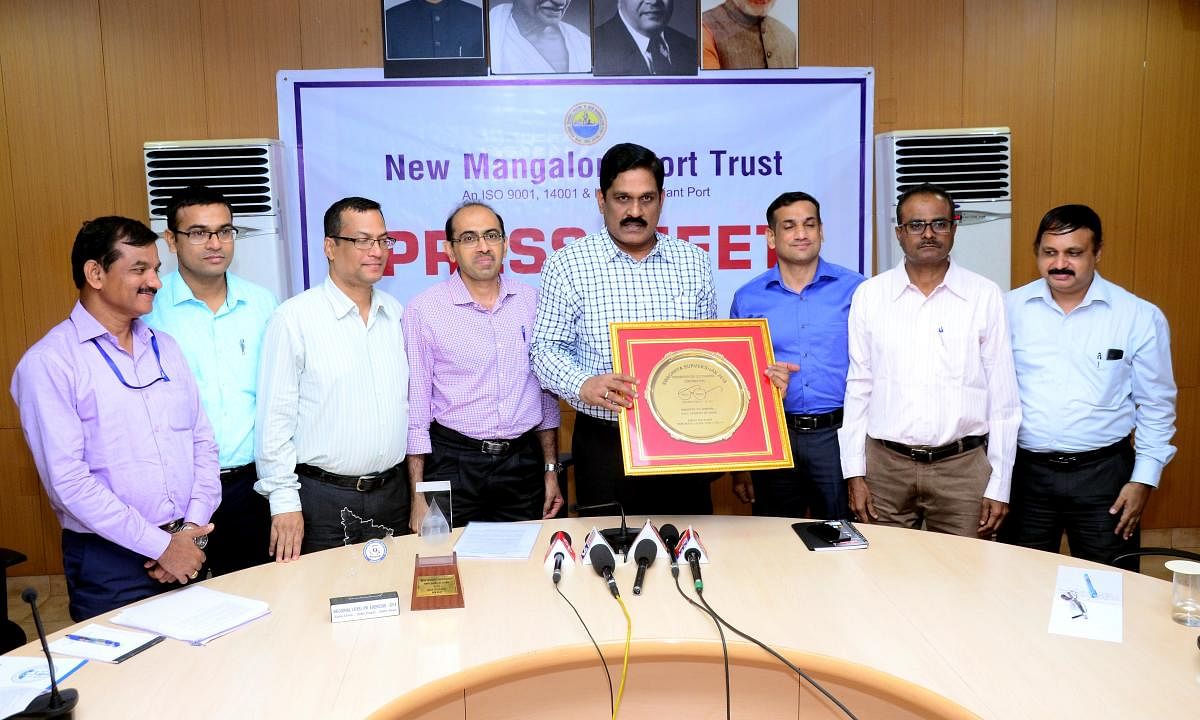 NMPT chairman M T Krishna Babu and other staff members seen with the Swachhata Sarvekshan Award instituted by the Ministry of Shipping for the cleanest port.