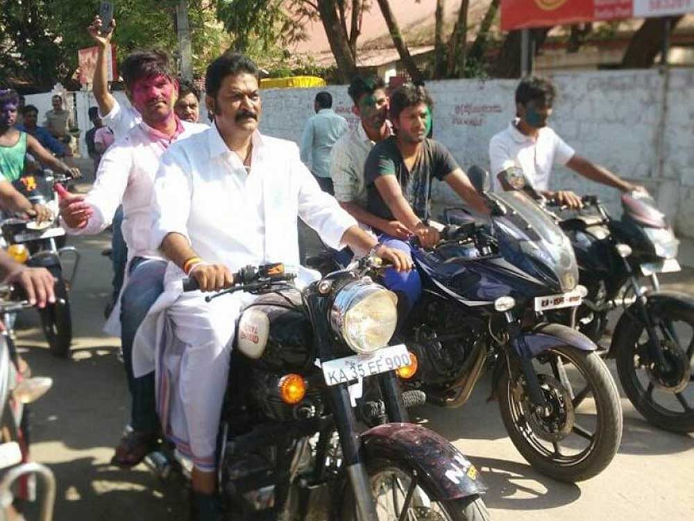 Once Upon a Time: Anand Singh with J N Ganesh (riding pillion) in happier times. DH photo