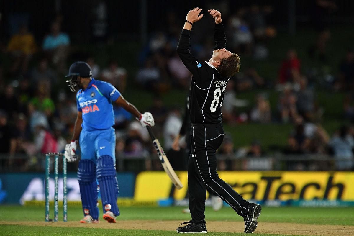 New Zealand's Lockie Ferguson (R) reacts to a dropped catch off the batting India's Ambati Rayudu (L) during the first one-day international (ODI) cricket match between New Zealand and India at McLean Park in Napier. AFP photo