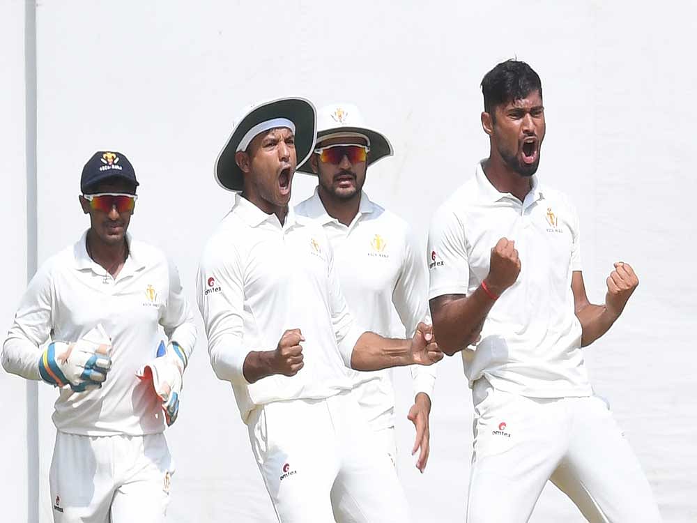 Karnataka bowler Ronit More (right) exults after bagging a Saurashtra wicket during the Ranji Trophy semifinal in Bengaluru on Friday. Picture credit: Srikanta Sharma R/ DH Photo