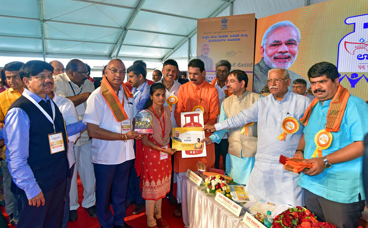 hairman of the Parliamentary Standing Committee on Petroleum and Natural Gas Pralhad Joshi and Union Minister Ramesh Jigajinagi hand over a sanction letter of LPG connection to a beneficiary at Prime Minister’s Ujjwala Yojana beneficiaries’ convention, held at B C Road in Bantwal on Friday. 