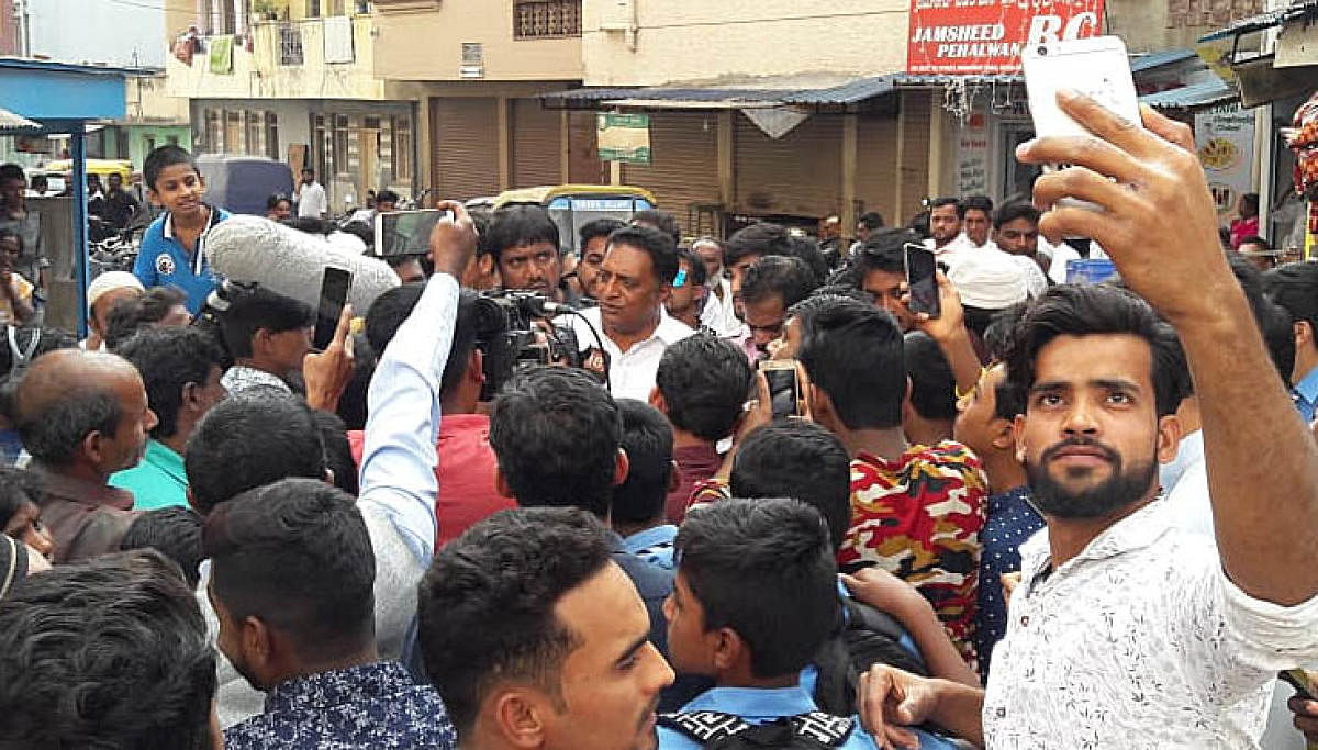Crowd puller: Multilingual actor Prakash Raj interacts with the residents of Shivajinagar on Friday.
