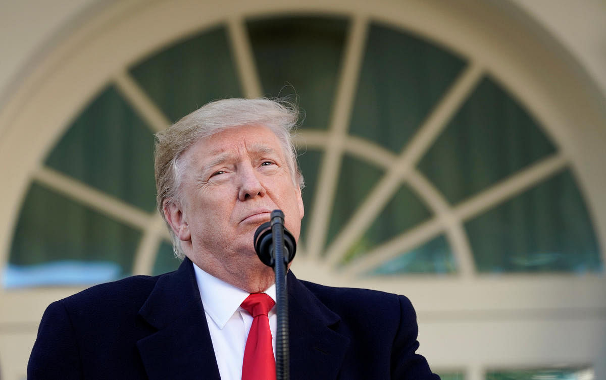 US President Donald Trump pauses as he announces a deal to end the partial government shutdown as while speaking in the Rose Garden of the White House in Washington. (REUTERS)