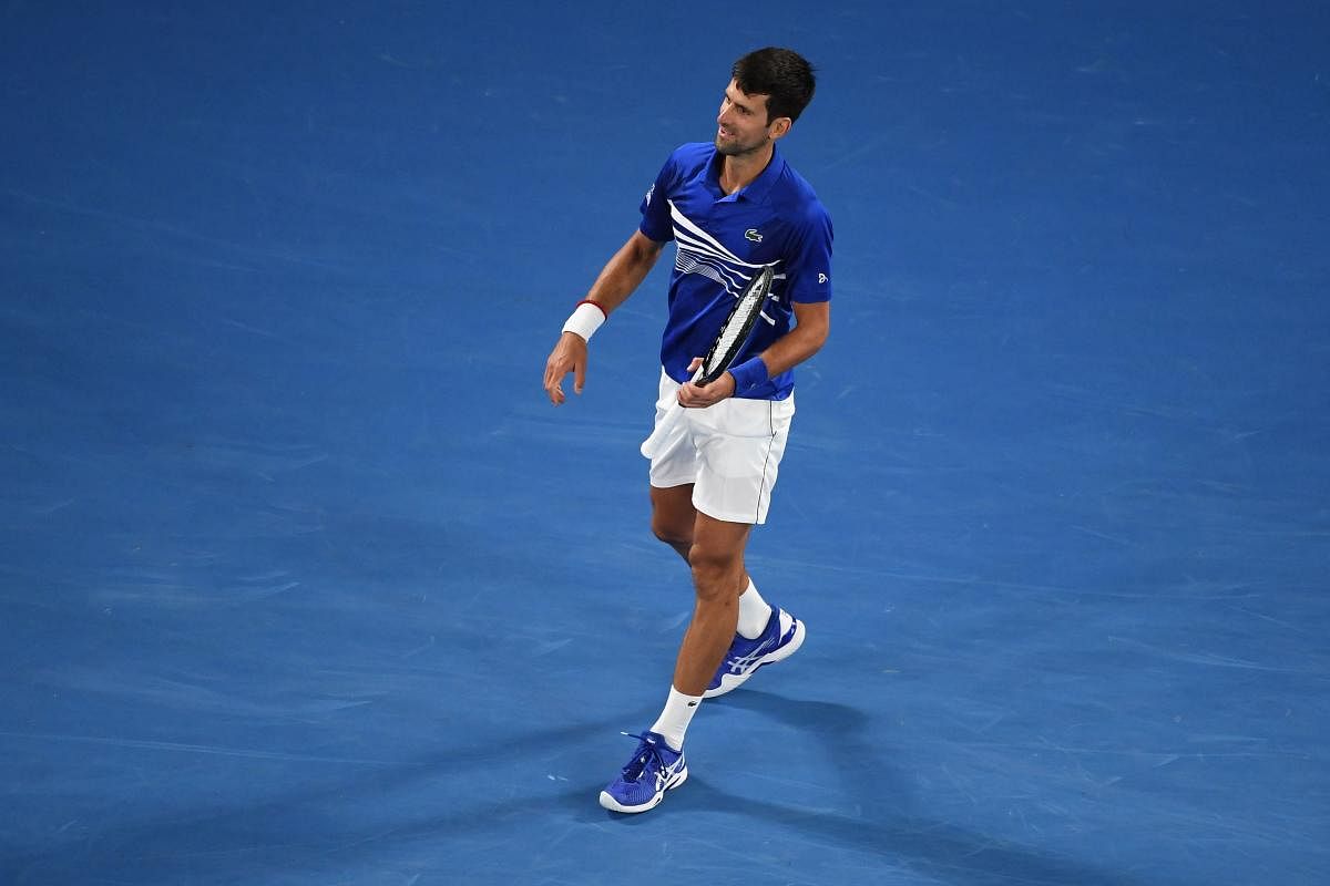 Serbia's Novak Djokovic celebrates his victory against Spain's Rafael Nadal during the men's singles final on day 14 of the Australian Open tennis tournament in Melbourne on January 27, 2019. (Photo by William WEST / AFP)