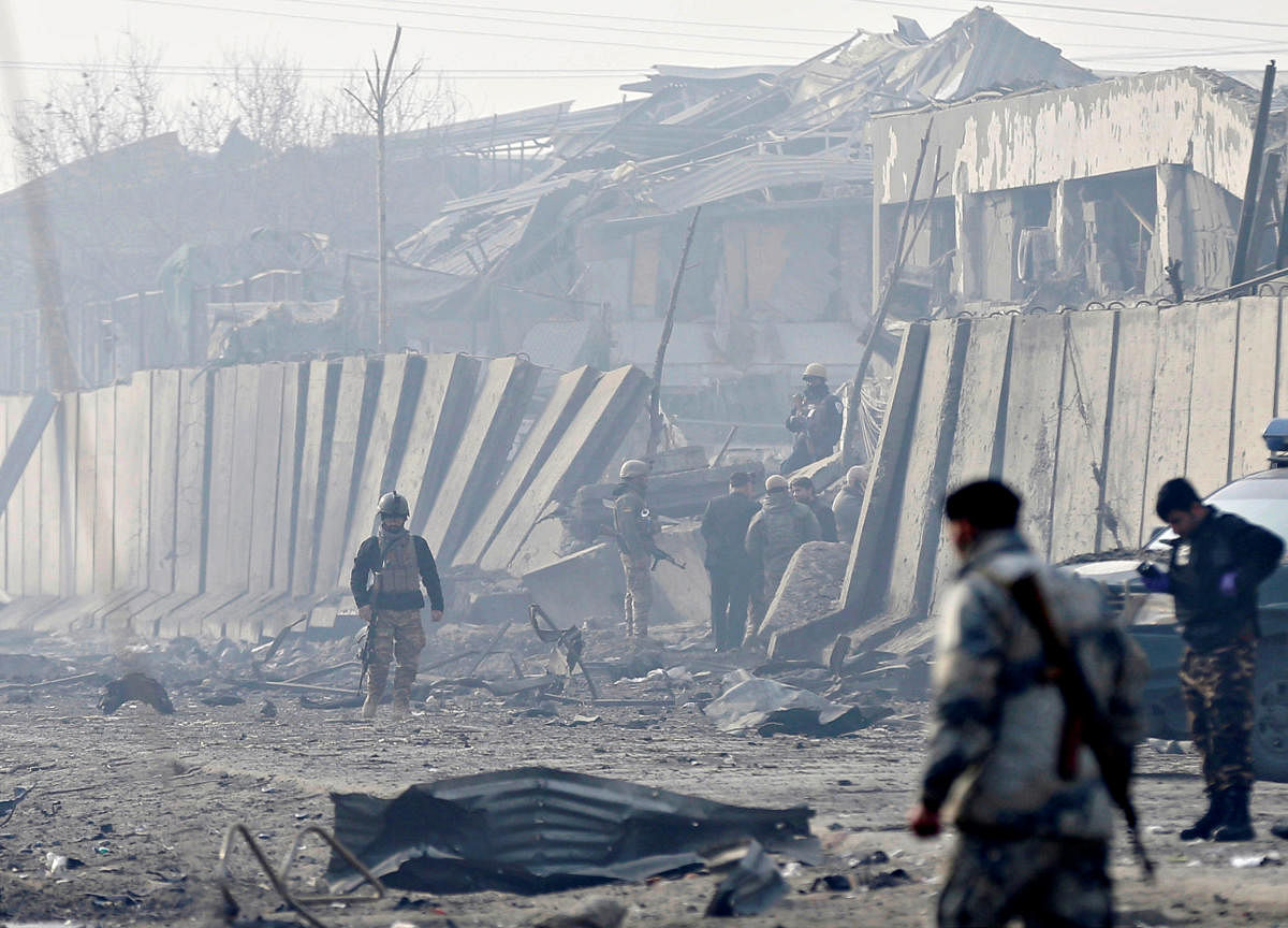 Afghan security forces inspect the site of a bomb blast in Kabul, Afghanistan, on Tuesday. (REUTERS)