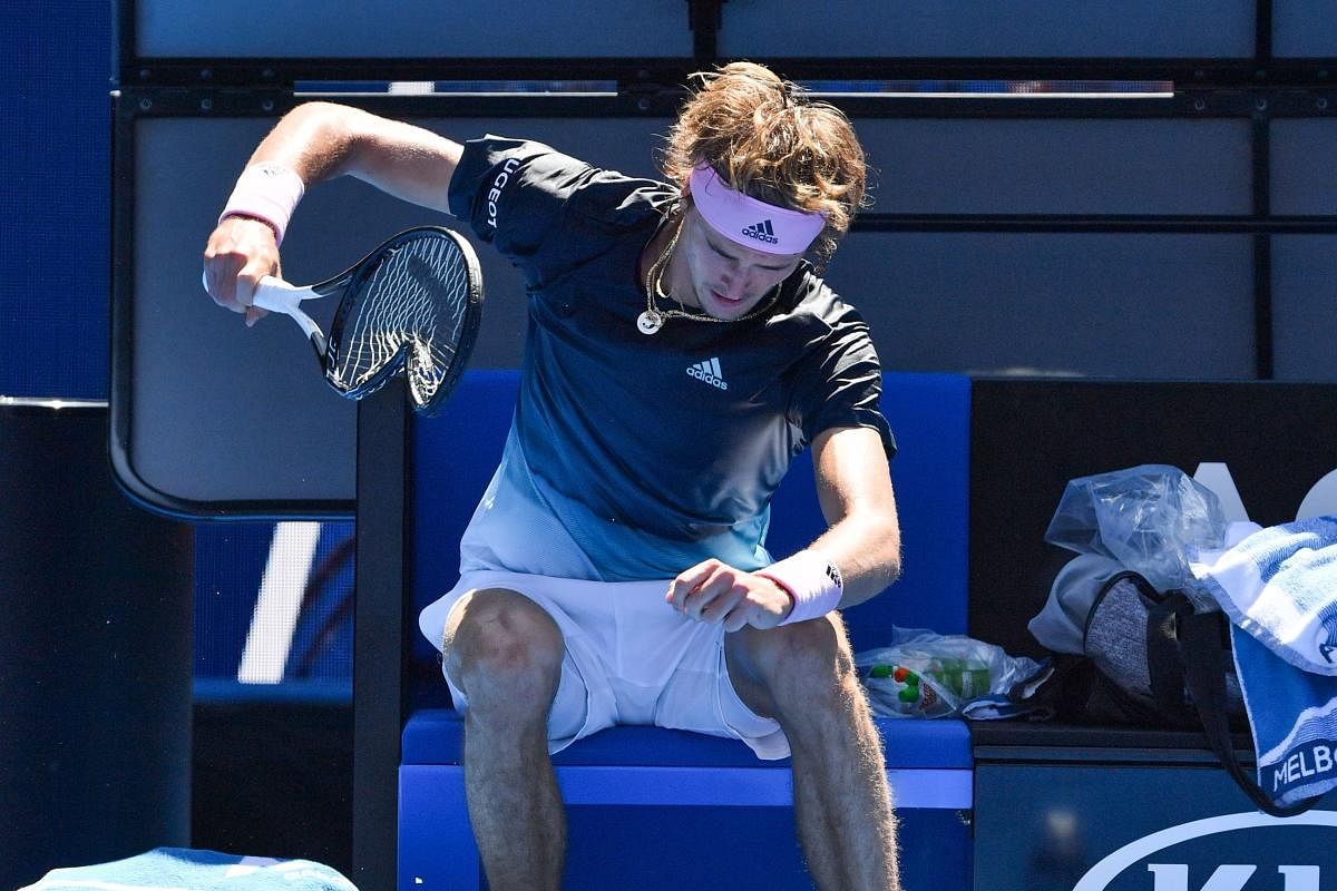 An upset Alexander Zverev took out his frustration on the racquet, smashing it several times to the ground. AFP
