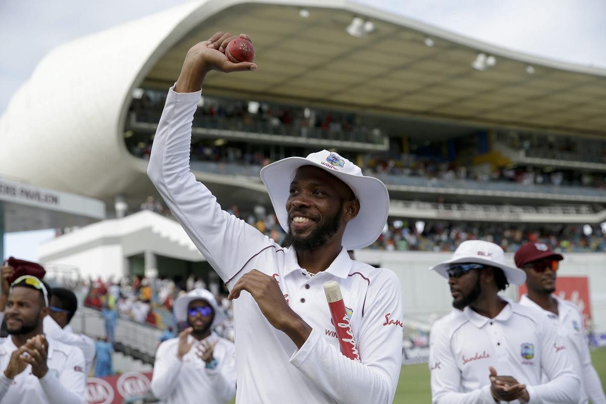 Roston Chase celebrates after bowling West Indies to victory in the first Test against England in Bridgetown, Barbados, on Saturday.