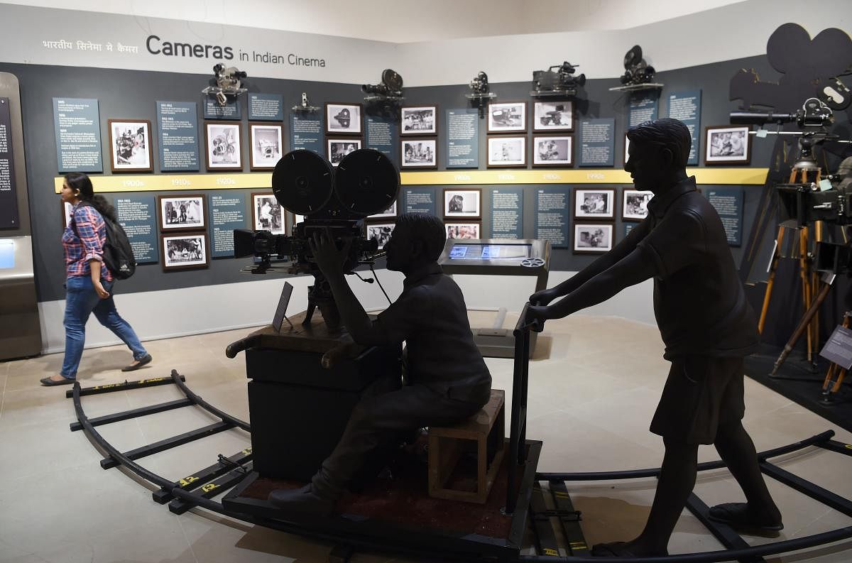 In this picture taken on January 22, 2019, an Indian student (R) visits the National Museum of Indian Cinema (NMIC), the country's first museum showcasing the history of its film industry, in Mumbai. AFP