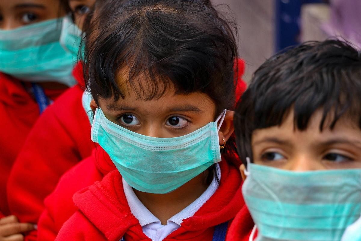 Students, wearing masks as protection against Swine Flu, attend a class at a school in Ajmer, Wednesday. PTI photo