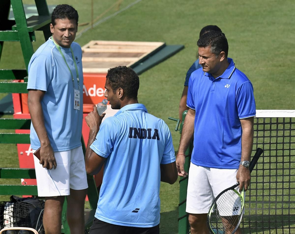 India's non-playing captain Mahesh Bhupathi with coach Jishan Ali and player Ramkumar Ramanathan during a training session ahead of Davis Cup match against Italy in Kolkata. PTI photo