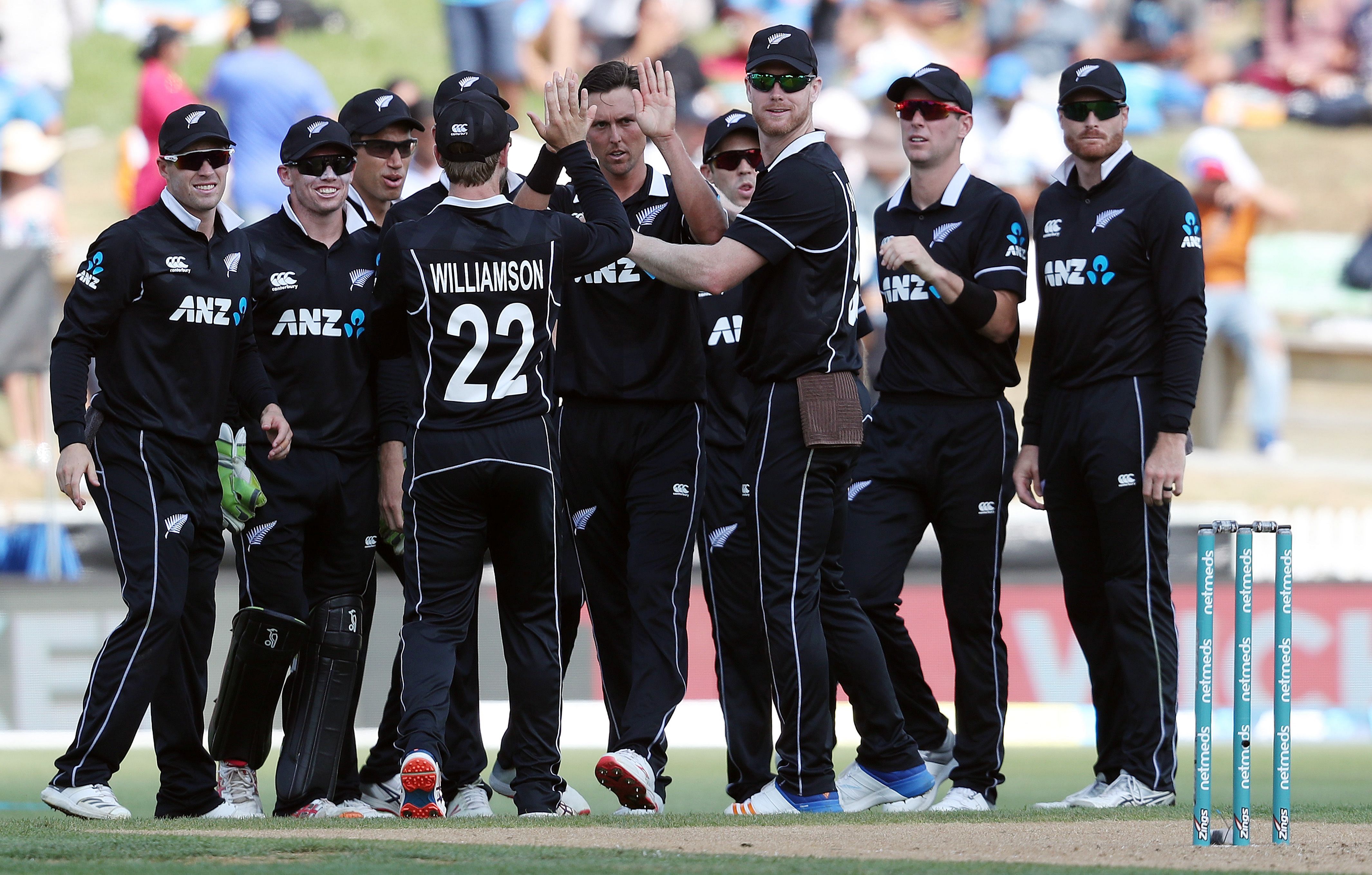 New Zealand's Trent Boult (centre) celebrates with team-mates after dismissing India's Kedar Jadhav on Thursday. AFP