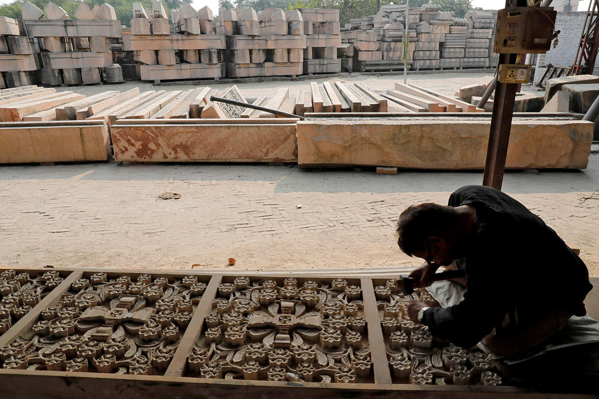 BRICK BY BRICK: A worker engraves a stone that Hindu groups say will be used to build a Ram temple in Ayodhya. REUTERS FILE