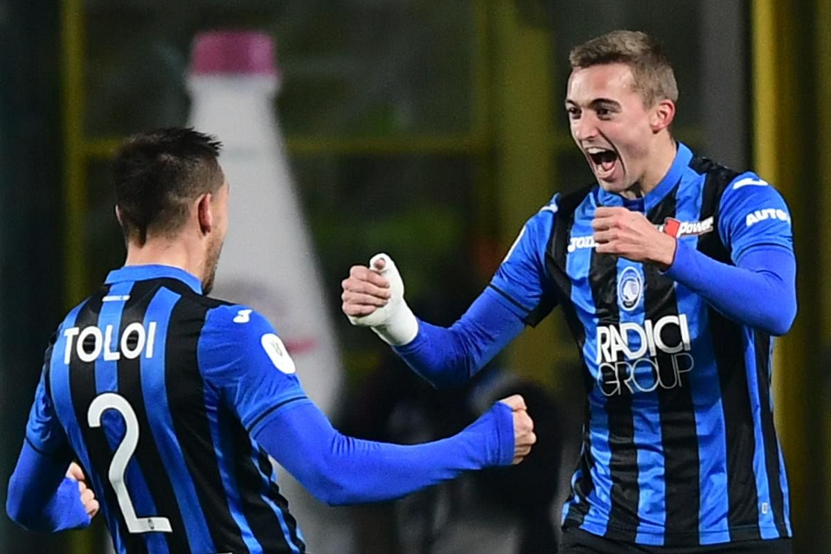 Atalanta's Timothy Castagne (right) celebrates with team-mate Rafael Toloi after scoring the opening goal against Juventus on Wednesday. AFP