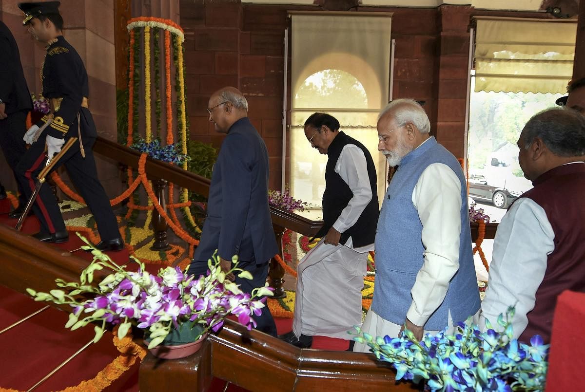 President Ram Nath Kovind, accompanied by Vice President M. Venkaiah Naidu and Prime Minister Narendra Modi, proceeds towards the Central Hall of Parliament to address the joint session of both the Houses on the first day of Budget Session. PTI photo