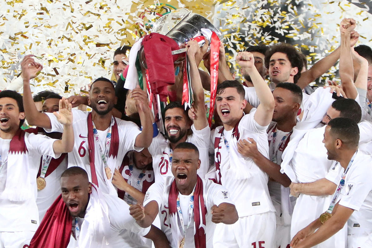 UNSTOPPABLE: Qatar players are over the moon as they lift their maiden Asian Cup on Friday. REUTERS