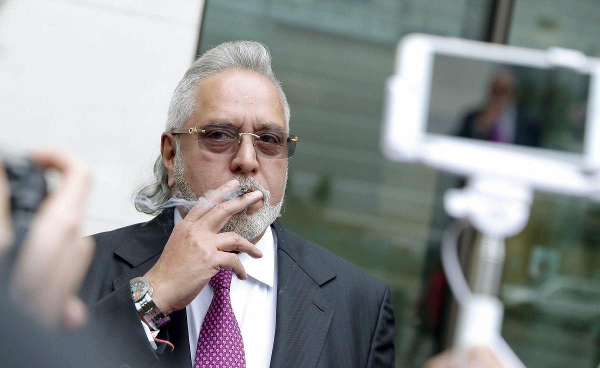 London : F1 Force India team boss Vijay Mallya smokes a cigarette outside Westminster Magistrates Court during a break for lunch as he attends a hearing at the court in London, Wednesday, Sept. 12, 2018. Mallya, once a leading figure among India's busines