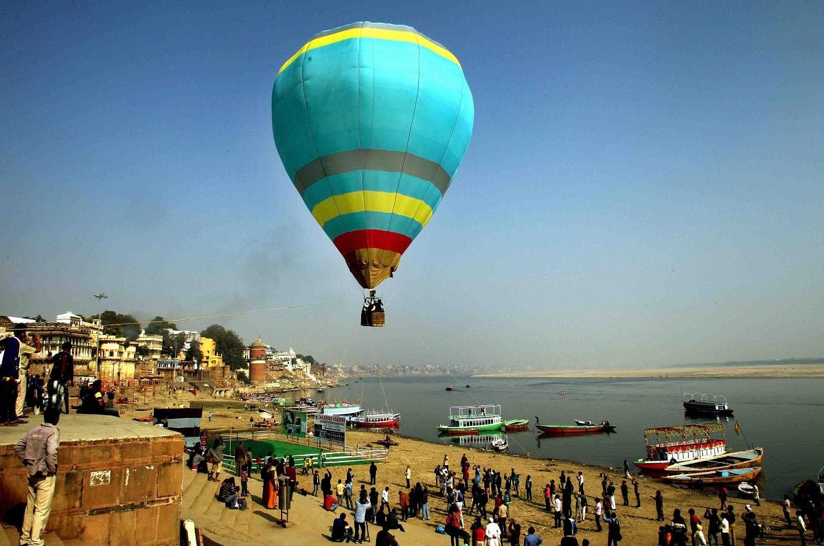 Tourists enjoy hot-air hot-air balloon rides above the historic Assi ghat in Varanasi. PTI file photo