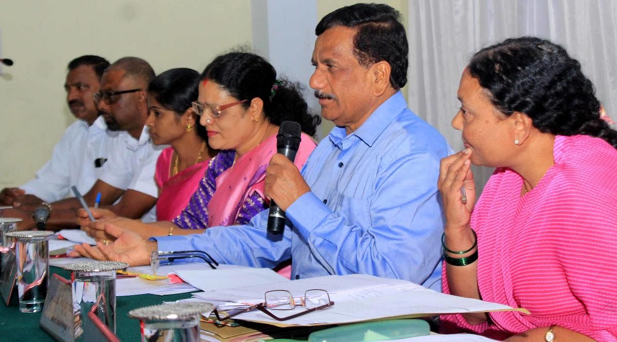 MLA K G Bopaiah speaks at the quarterly review meeting of KDP at Madikeri Taluk Panchayat on Saturday.