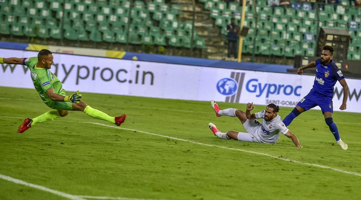 Chennaiyin FC's CK Vineeth (blue jersey) scores against FC Pune City during their ISL match in Chennai on Saturday. PTI