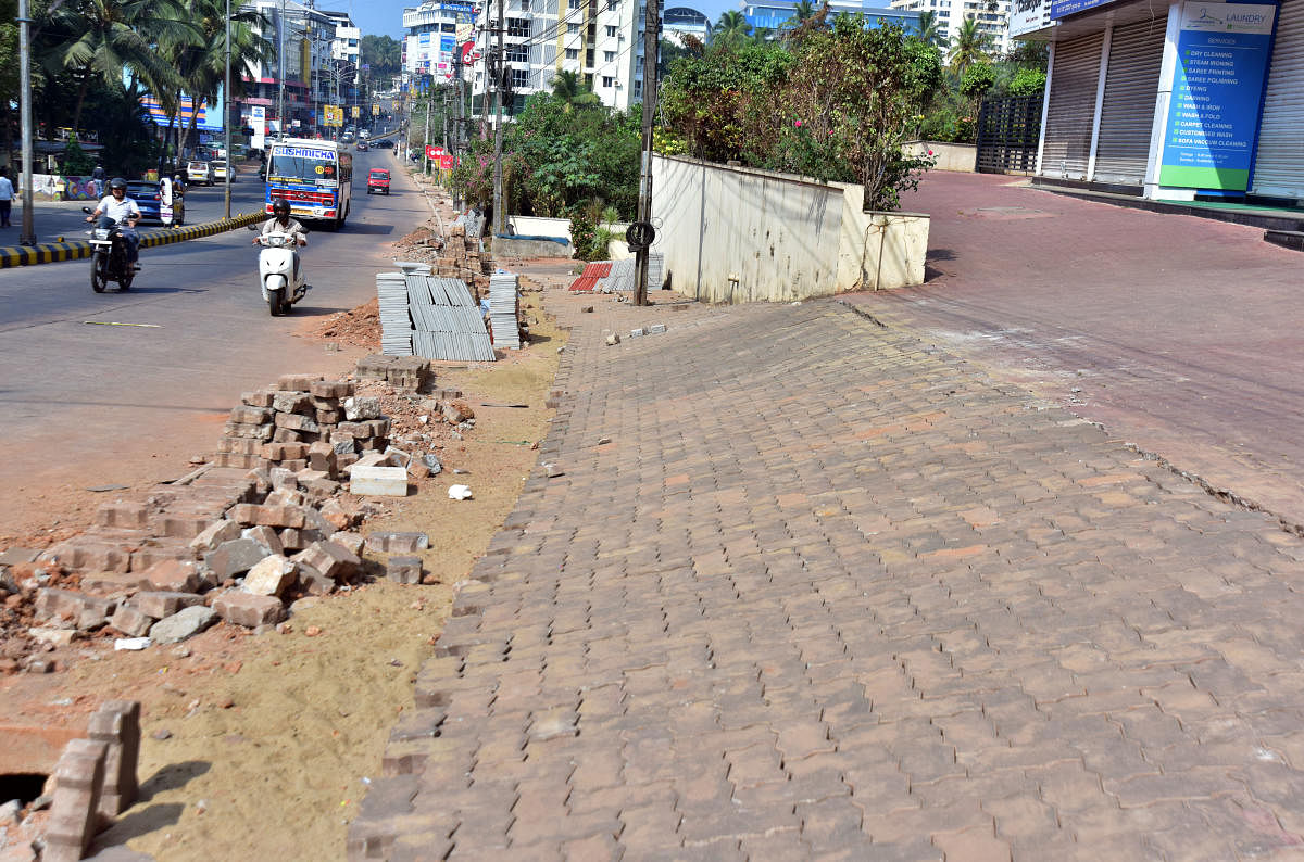 Construction materials being carelessly dumped along Bejai Main Road in Mangaluru.