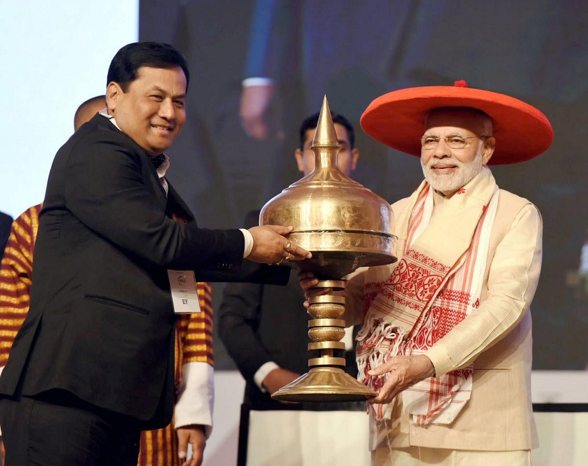 Prime Minister Narendra Modi being felicitated by Assam Chief Minister Sarbananda Sonowal during the inauguration of Advantage Assam programme at Indira Gandhi Athletic Stadium, in Guwahati on Saturday. (PTI File Photo)