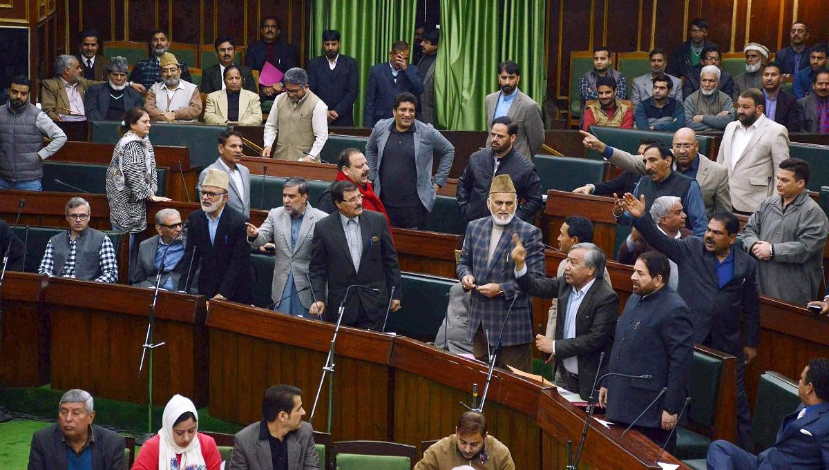 National Conference and Congress MLA's protest inside the J&amp;K Legislative assembly during the budget session in Jammu on Wednesday. PTI