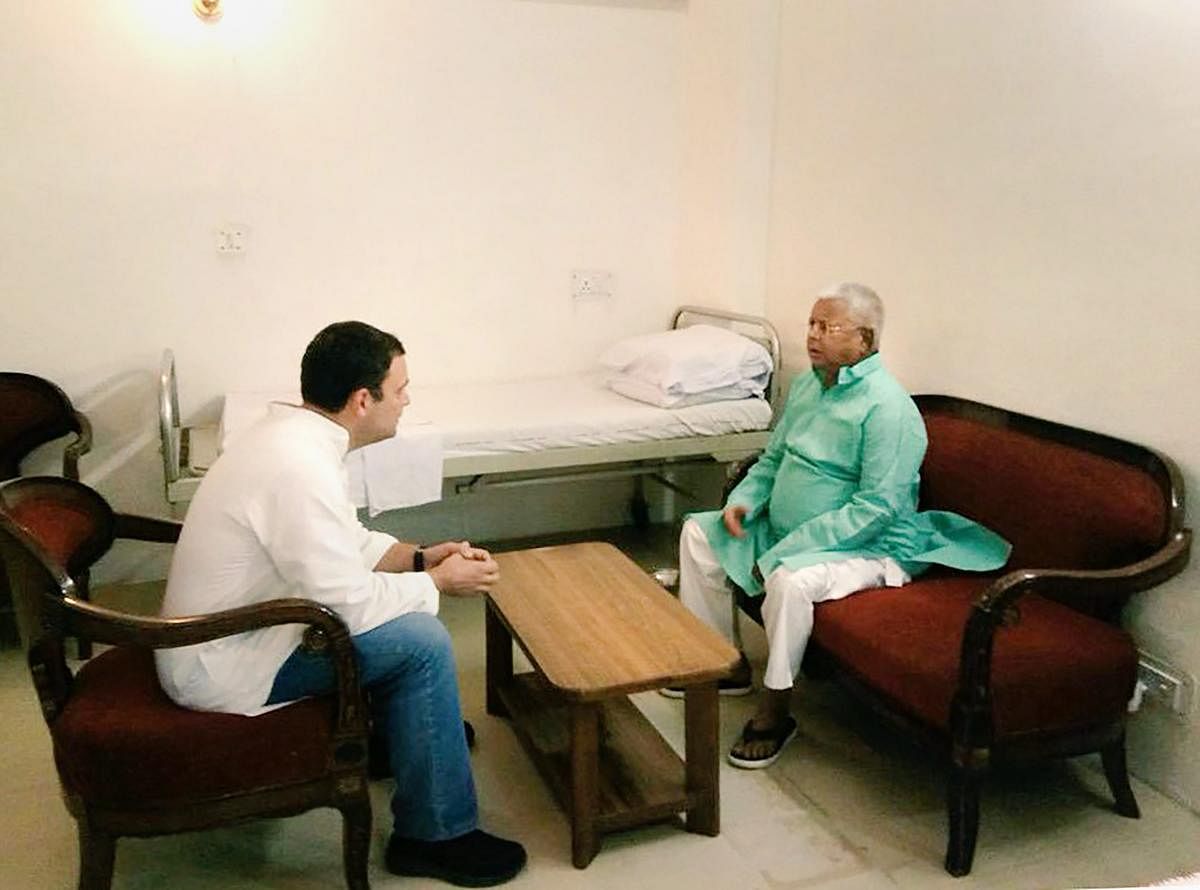 Congress President Rahul Gandhi meets RJD chief Lalu Prasad to inquire about his health at All India Institute of Medical Sciences (AIIMS) in New Delhi on Monday. PTI Photo / @RJDforIndia Twitter.