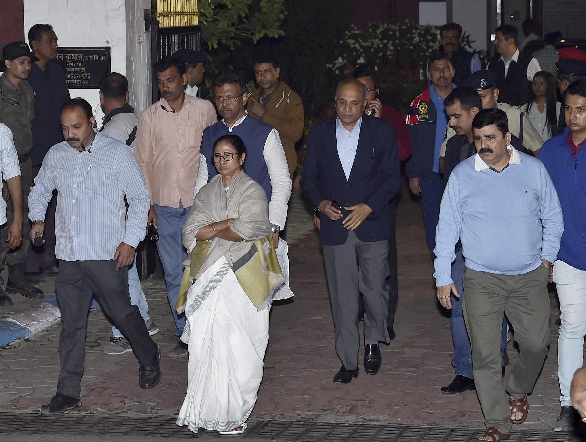 Mamata Banerjee comes out from Kolkata Police Commissioner Rajeev Kumar's residence, after CBI officials came to question the commissioner in connection with the Saradha ponzi scam. in Kolkata. PTI
