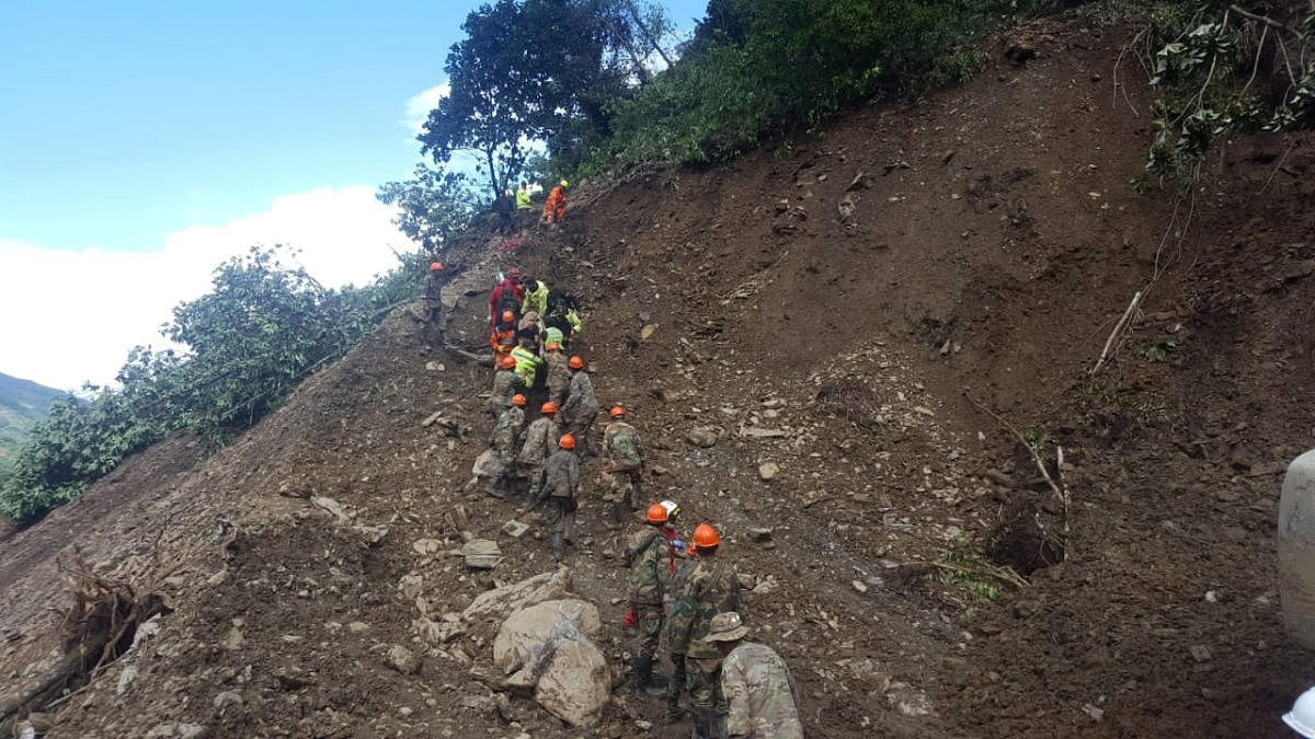 Soldiers and members of a rescue team are seen after a landslide due to heavy rains near Caranavi in La Paz Department, Bolivia