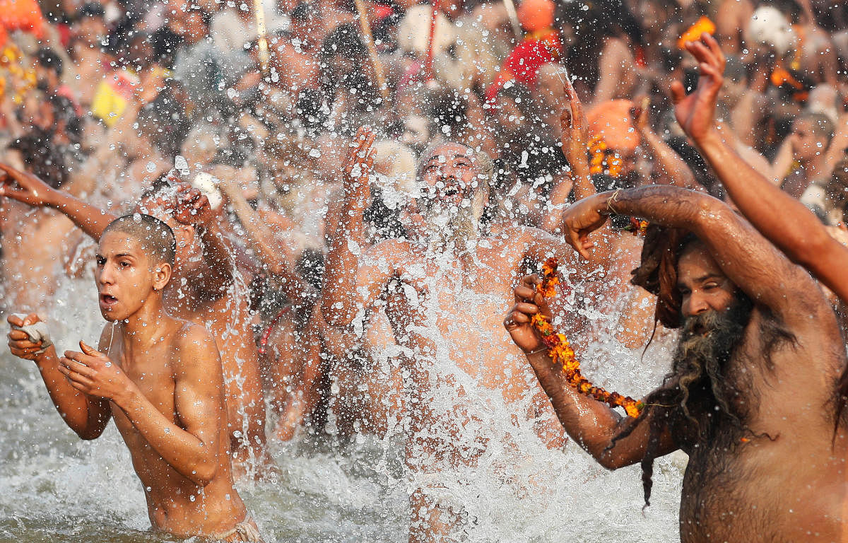 Naga Sadhus take a dip during the second "Shahi Snan" (grand bath) at "Kumbh Mela" in Prayagraj. (Reuters Photo)
